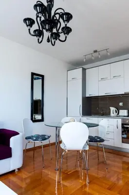a dining room and kitchen with a table and chairs at Apartment Taurus in Petrovac na Moru