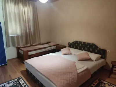 a bedroom with a bed and a table and a window at Tangerine terrace in Ulcinj