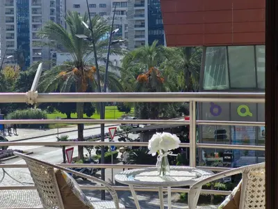 a table with a vase of flowers on a balcony at Diva Residence in Budva