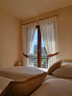 a bedroom with two beds and a window at Diva Residence in Budva