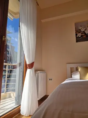 a bedroom with a bed and a large window at Diva Residence in Budva
