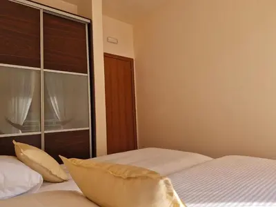 a bedroom with two beds and a large window at Diva Residence in Budva