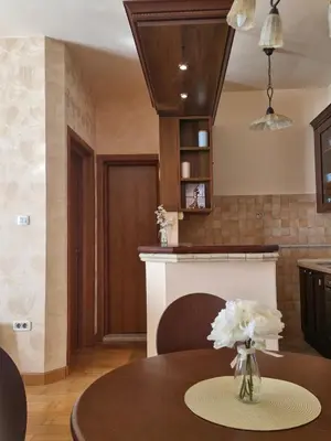 a kitchen with a table with a vase of flowers on it at Diva Residence in Budva