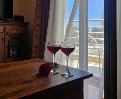 two glasses of red wine sitting on a table at Diva Residence in Budva