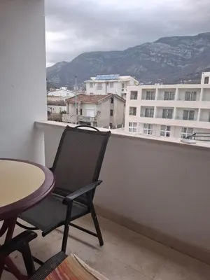 a chair sitting on a balcony with a table at Apartments D&D Sutomore in Sutomore