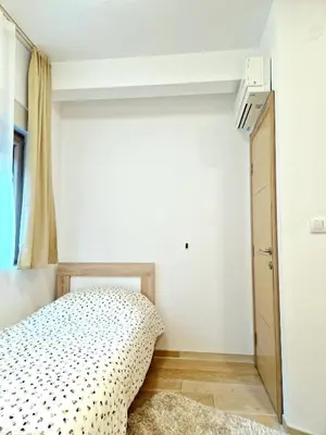 a bedroom with a bed and a dresser in it at Apartman BJANKA in Budva