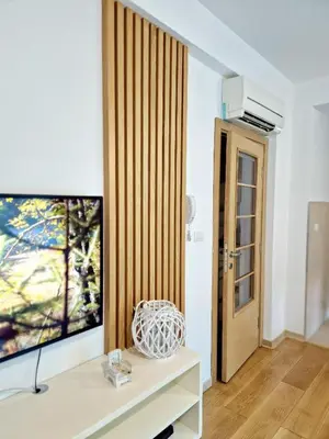 a living room with a flat screen tv on a table at Apartman BJANKA in Budva