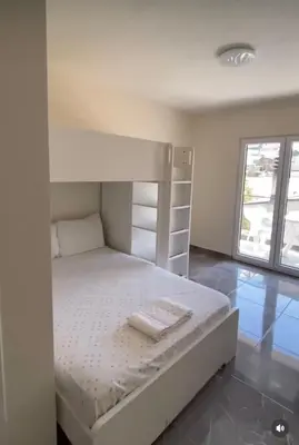a bed in a room with a white bunk bed at Fenix Apartmani Dubrava in Dobra Voda