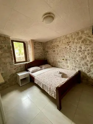 a bedroom with a bed and a window at Apartments Bella in Kotor