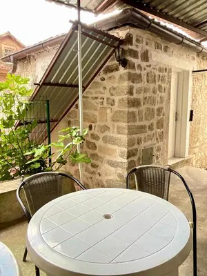 a white table and chairs on a patio at Apartments Bella in Kotor