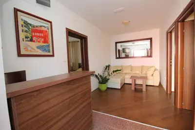 a living room with a couch and a mirror at Apartment Biba in Virpazar