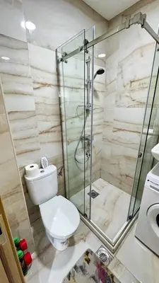 a bathroom with a toilet and a glass shower at Apartmani Bar Zeleni Pojas in Bar