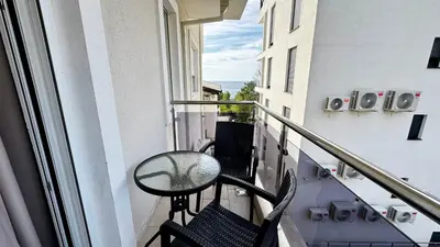 a balcony with a table and chairs on a building at Apartmani Bar Zeleni Pojas in Bar