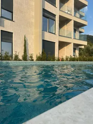 a swimming pool in front of a building at Nicks sea view appartement II in Petrovac na Moru
