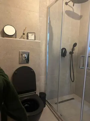 a bathroom with a shower with a toilet and a glass door at Nicks sea view appartement II in Petrovac na Moru