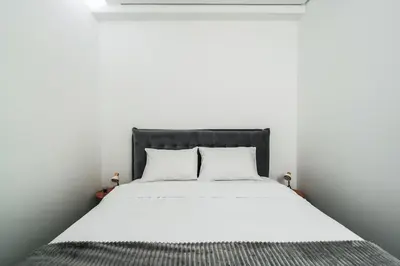 a white bed with two pillows in a white room at Como residence by InProperty in Budva
