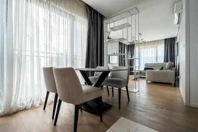 a dining room with a table and chairs at Como residence by InProperty in Budva
