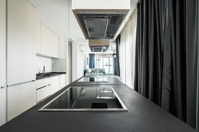 a kitchen with a counter with a sink in it at Como residence by InProperty in Budva