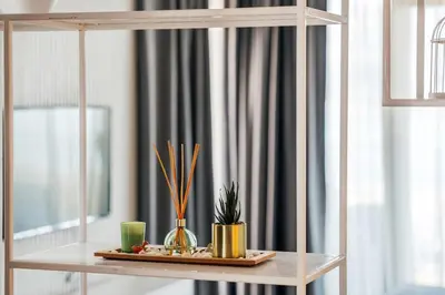 a shelf with vases and plants on a table at Como residence by InProperty in Budva