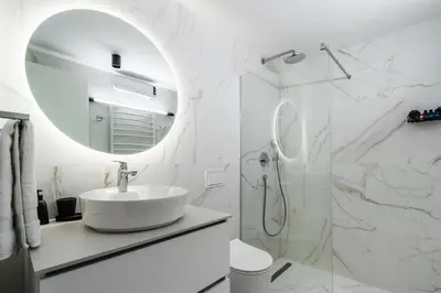 a white bathroom with a sink and a mirror at Como residence by InProperty in Budva