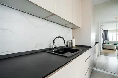 a kitchen with a sink and a counter top at Como residence by InProperty in Budva