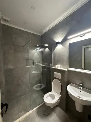 a bathroom with a toilet and a sink and a shower at Vue Mer in Ulcinj