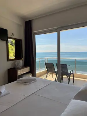 a bedroom with a bed and a view of the ocean at Vue Mer in Ulcinj