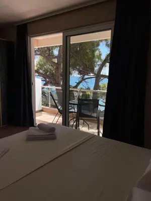 a bedroom with a bed and a view of a patio at Vue Mer in Ulcinj