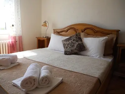 a bedroom with a bed with towels on it at Apartment Djukovic in Petrovac na Moru