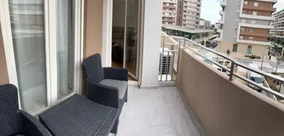 a balcony with two chairs on a building at Stylish one bedroom apartment Central Point with -GARAGE 5 EUR PER DAY in Podgorica