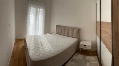 a bedroom with a large bed in a room at Stylish one bedroom apartment Central Point with -GARAGE 5 EUR PER DAY in Podgorica