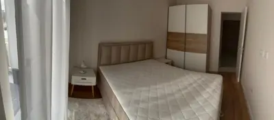 a small bedroom with a bed with a white mattress at Stylish one bedroom apartment Central Point with -GARAGE 5 EUR PER DAY in Podgorica