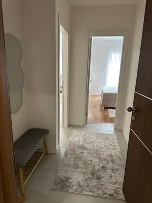 a room with a hallway with a bed and a door at Stylish one bedroom apartment Central Point with -GARAGE 5 EUR PER DAY in Podgorica