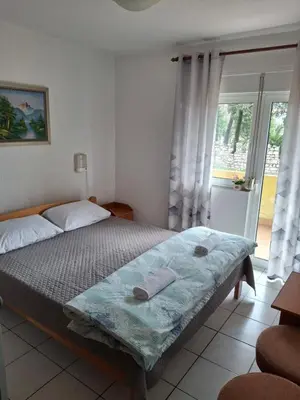 a bedroom with a bed and a window at Adriatica 1 in Sutomore