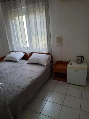 a small bedroom with a bed and a window at Adriatica 1 in Sutomore
