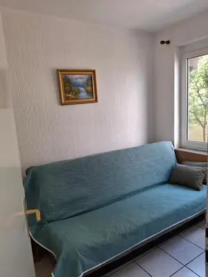 a blue couch in a room with a window at Adriatica 1 in Sutomore