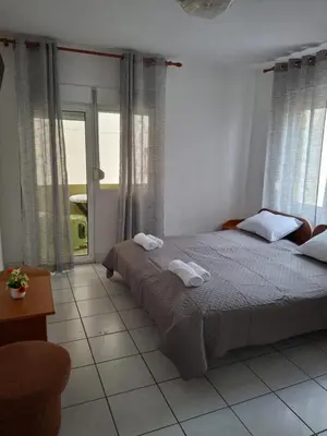 a bedroom with a bed with two towels on it at Adriatica 1 in Sutomore