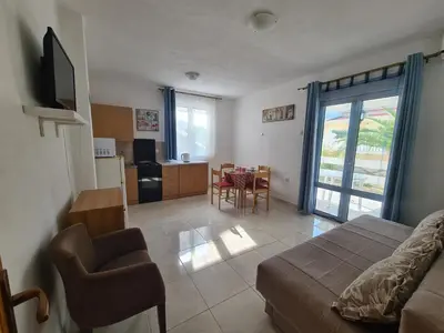 a living room with a bed and a dining room at Apartment Zeleny Pojas in Bar
