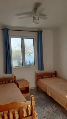 a bedroom with two beds and a window at Apartment Zeleny Pojas in Bar