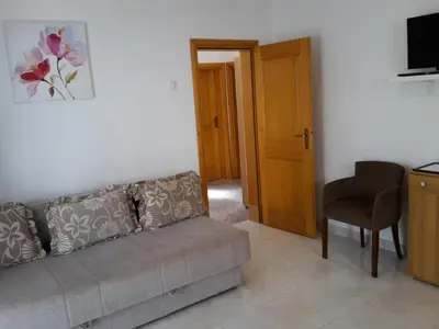 a living room with a couch and a chair at Apartment Zeleny Pojas in Bar