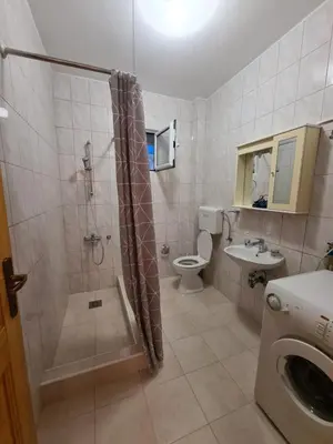 a bathroom with a shower and a toilet and a sink at Apartment Zeleny Pojas in Bar