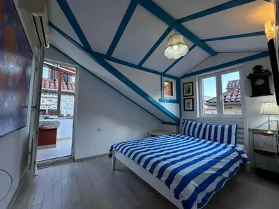 a blue and white bedroom with a bed and windows at Charming apartment with a terrace in Kotor