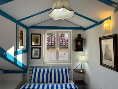 a bedroom with blue and white walls and a bed at Charming apartment with a terrace in Kotor