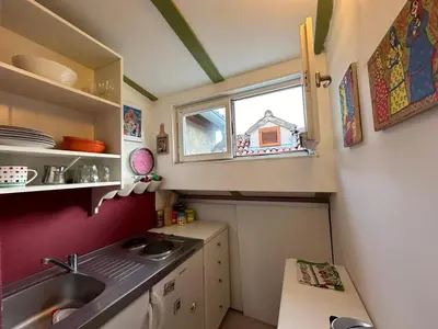 a small kitchen with a sink and a window at Charming apartment with a terrace in Kotor
