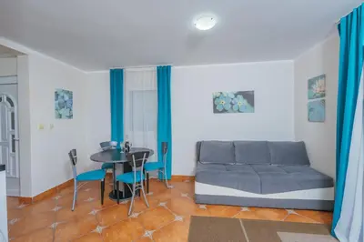 a living room with a couch and a table at Apartments Spin in Budva