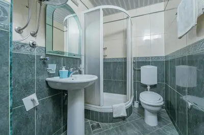 a bathroom with a toilet and a sink and a shower at Apartments Spin in Budva