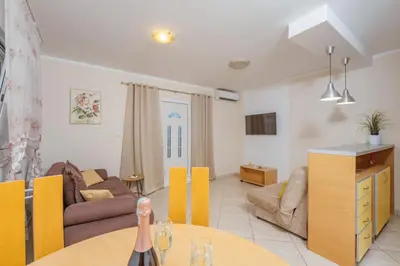 a living room with a table and a couch at Apartments Spin in Budva