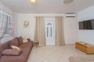 a living room with a brown couch and a door at Apartments Spin in Budva