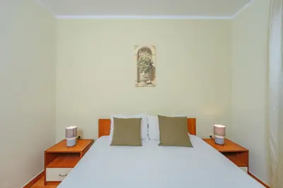 a bedroom with a white bed with two night stands at Apartments Spin in Budva