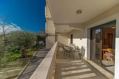 a balcony of a house with a table and chairs at Apartment Sofija Petrovac in Petrovac na Moru